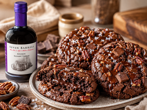Oversized Bourbon Balsamic brownie cookies with dark chocolate chunks, toasted pecans, caramel drizzle, flaky sea salt, and Seven Barrels Bourbon Balsamic Vinegar