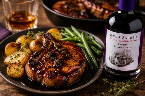 Bourbon balsamic glazed pork chops with roasted potatoes and green beans served with Seven Barrels balsamic