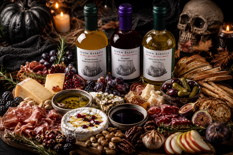 Haunted Harvest charcuterie board with artisan cheeses, cured meats, fruit, and Seven Barrels olive oils and balsamic vinegar