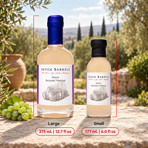 Two bottles of Seven Barrels White Balsamic Vinegar shown on a stone surface outdoors, labeled Large (375 mL / 12.7 fl oz) and Small (177 mL / 6.